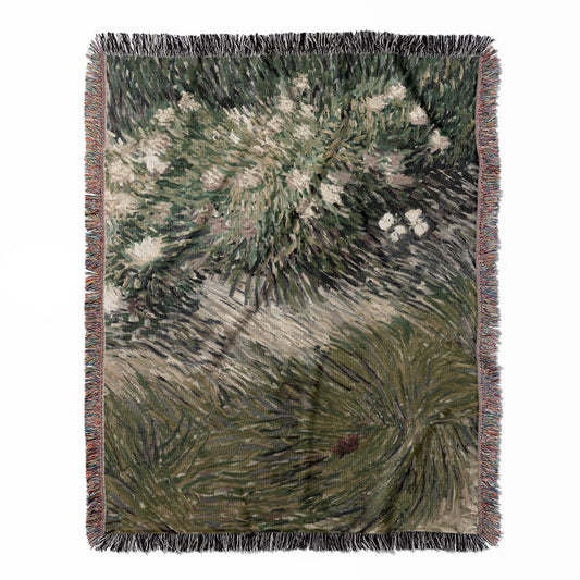 Sage Green woven throw blanket, made with 100% cotton, providing a soft and cozy texture with an abstract garden design for home decor.