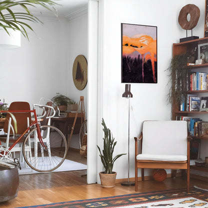 Eclectic living room with a road bike, bookshelf and house plants that features framed artwork of a Colorful and Unique above a chair and lamp