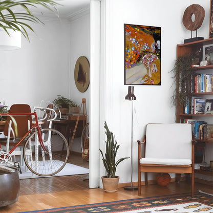 Eclectic living room with a road bike, bookshelf and house plants that features framed artwork of a Dreamlike Floral above a chair and lamp