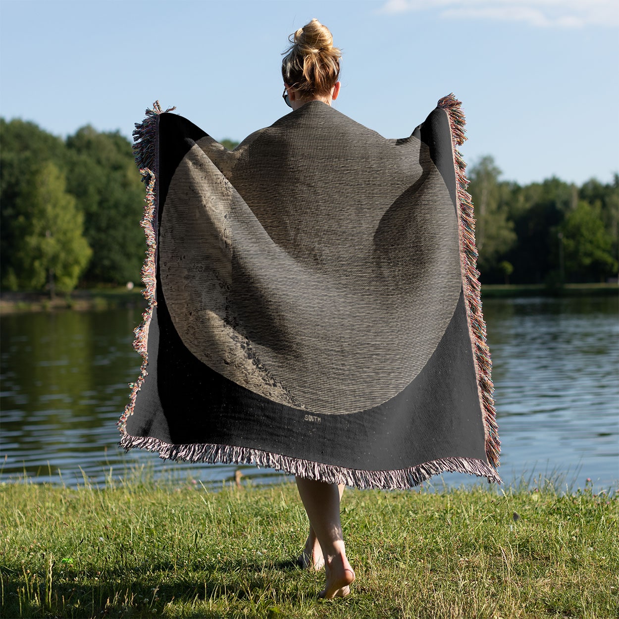 Astronomy Woven Blanket Held on a Woman's Back Outside