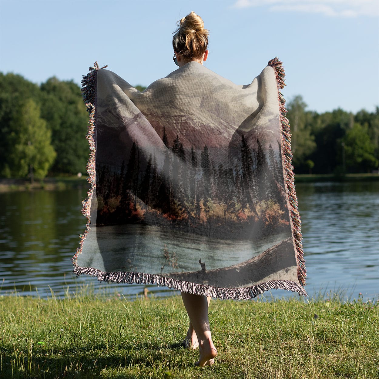 Beautiful Mountain Woven Blanket Held on a Woman's Back Outside