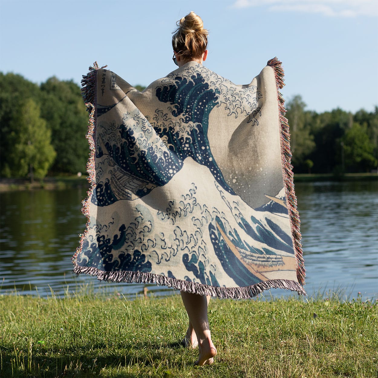 Big Wave Woven Blanket Held on a Woman's Back Outside
