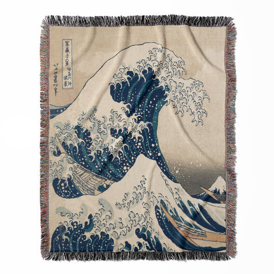 The Great Wave off Kanagawa woven throw blanket, crafted from 100% cotton, offering a soft and cozy texture with a big wave design for home decor.