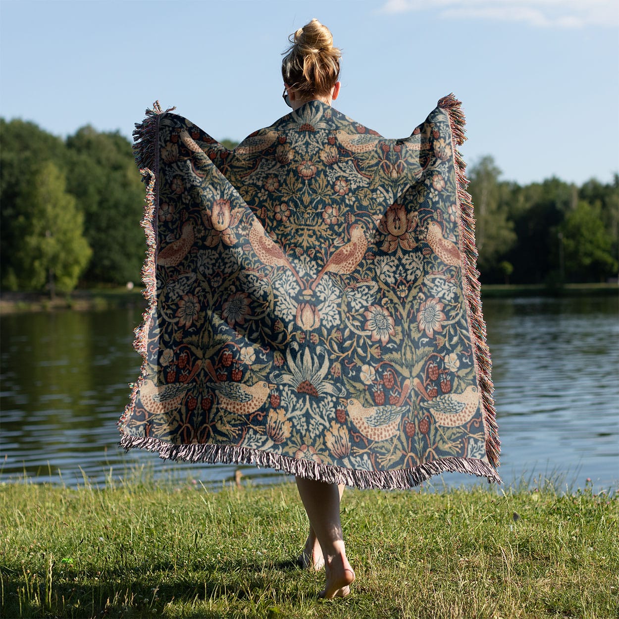 Birds and Plants Woven Blanket Held on a Woman's Back Outside