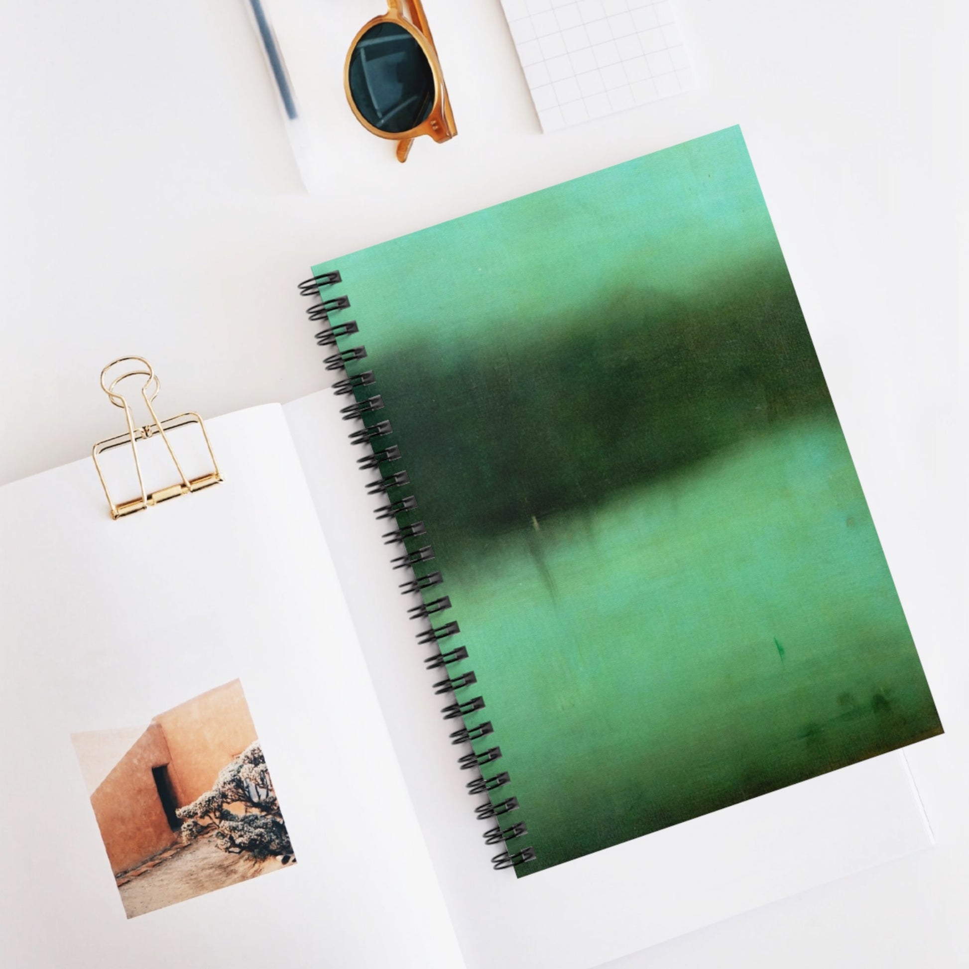 Black and Green Spiral Notebook Displayed on Desk