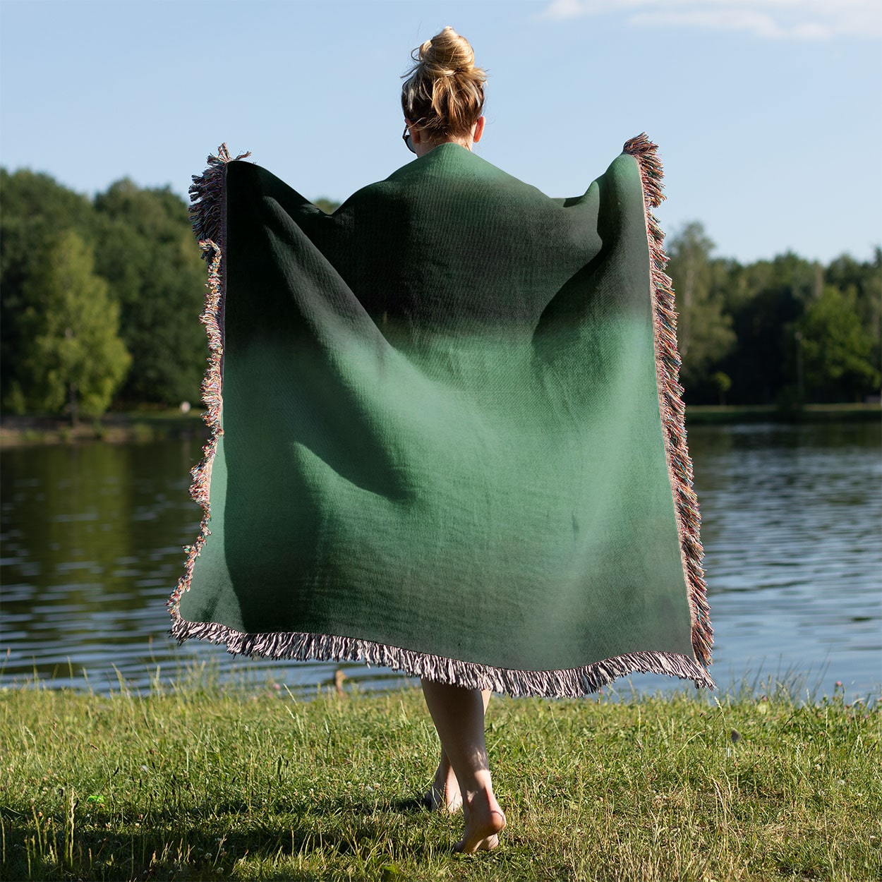 Black and Green Woven Blanket Held on a Woman's Back Outside