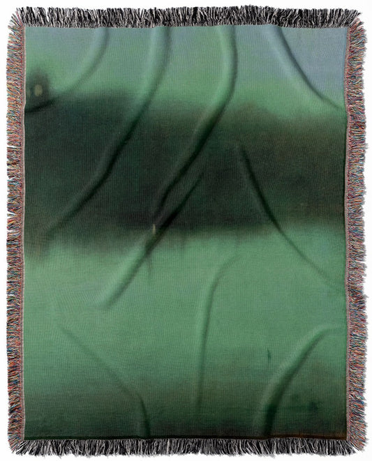 Black and Green woven throw blanket, made with 100% cotton, delivering a soft and cozy texture with an abstract moody design for home decor.