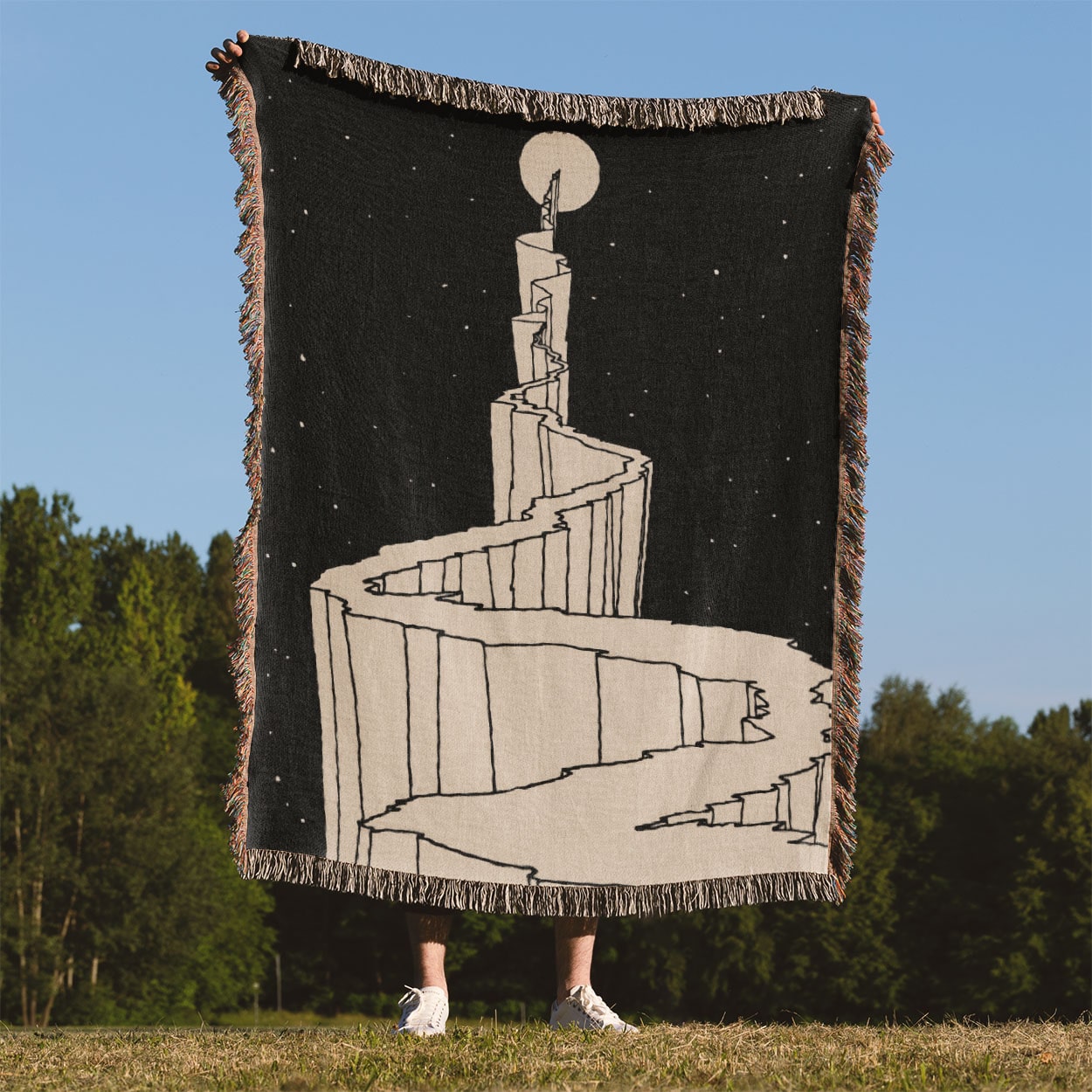 Black and White Fantasy Woven Blanket Held Up Outside