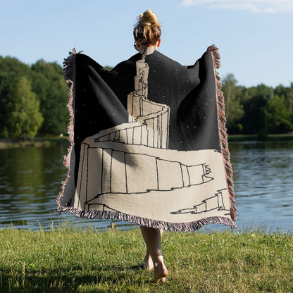Black and White Fantasy Woven Blanket Held on a Woman's Back Outside