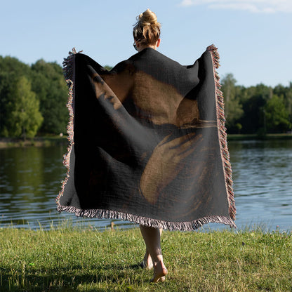 Black and White Moody Woven Throw Blanket Held on a Woman's Back Outside