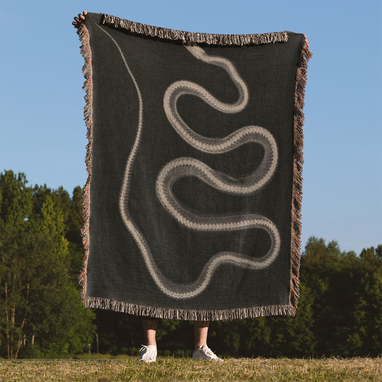 Black and White Snake Woven Throw Blanket Held Up Outside