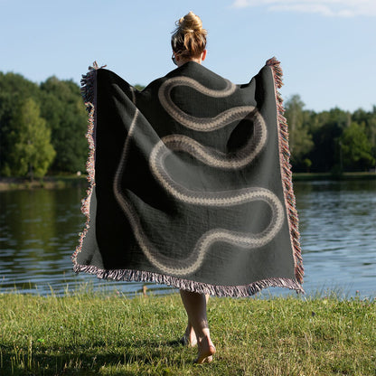 Black and White Snake Woven Throw Blanket Held on a Woman's Back Outside