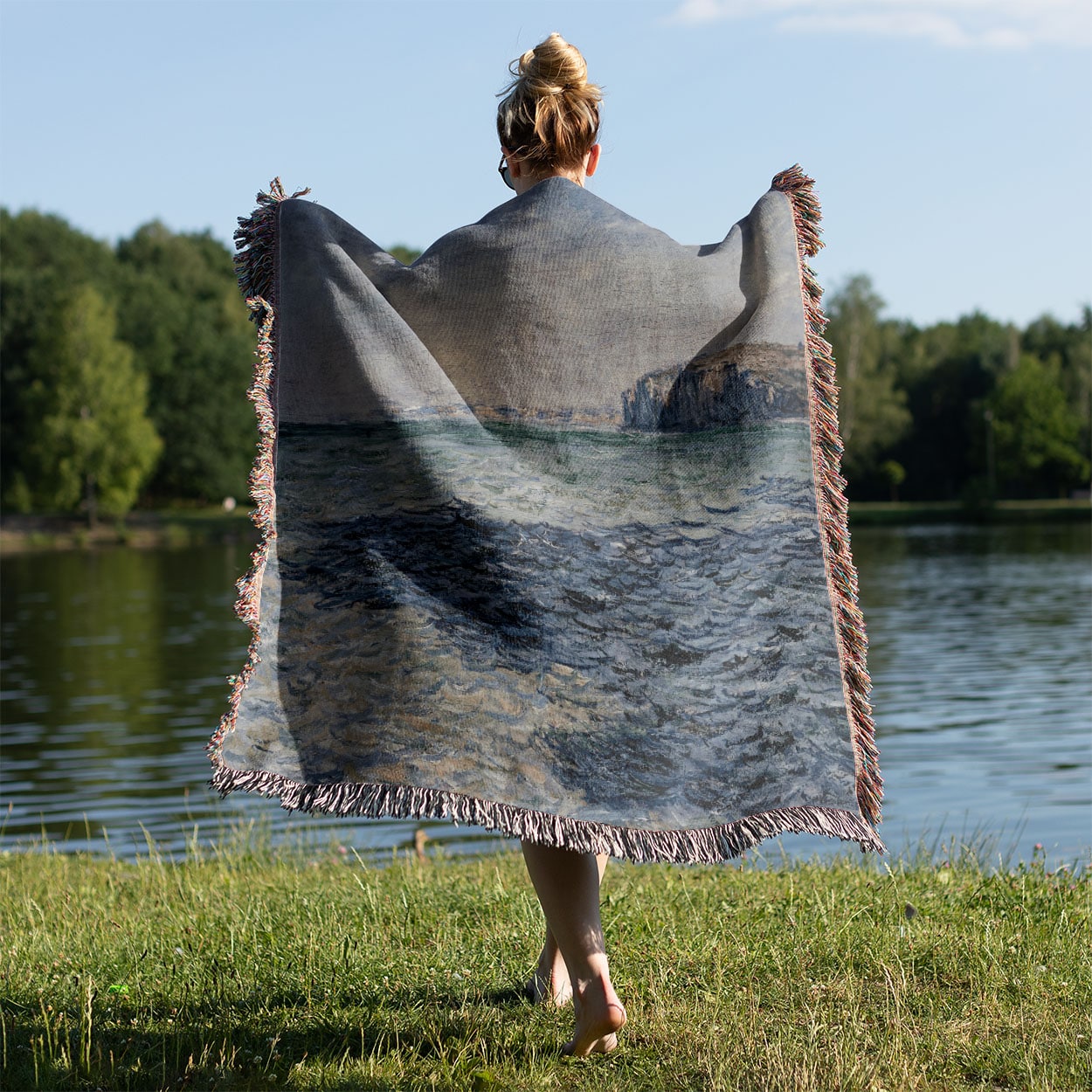 Blue Ocean Woven Throw Blanket Held on a Woman's Back Outside