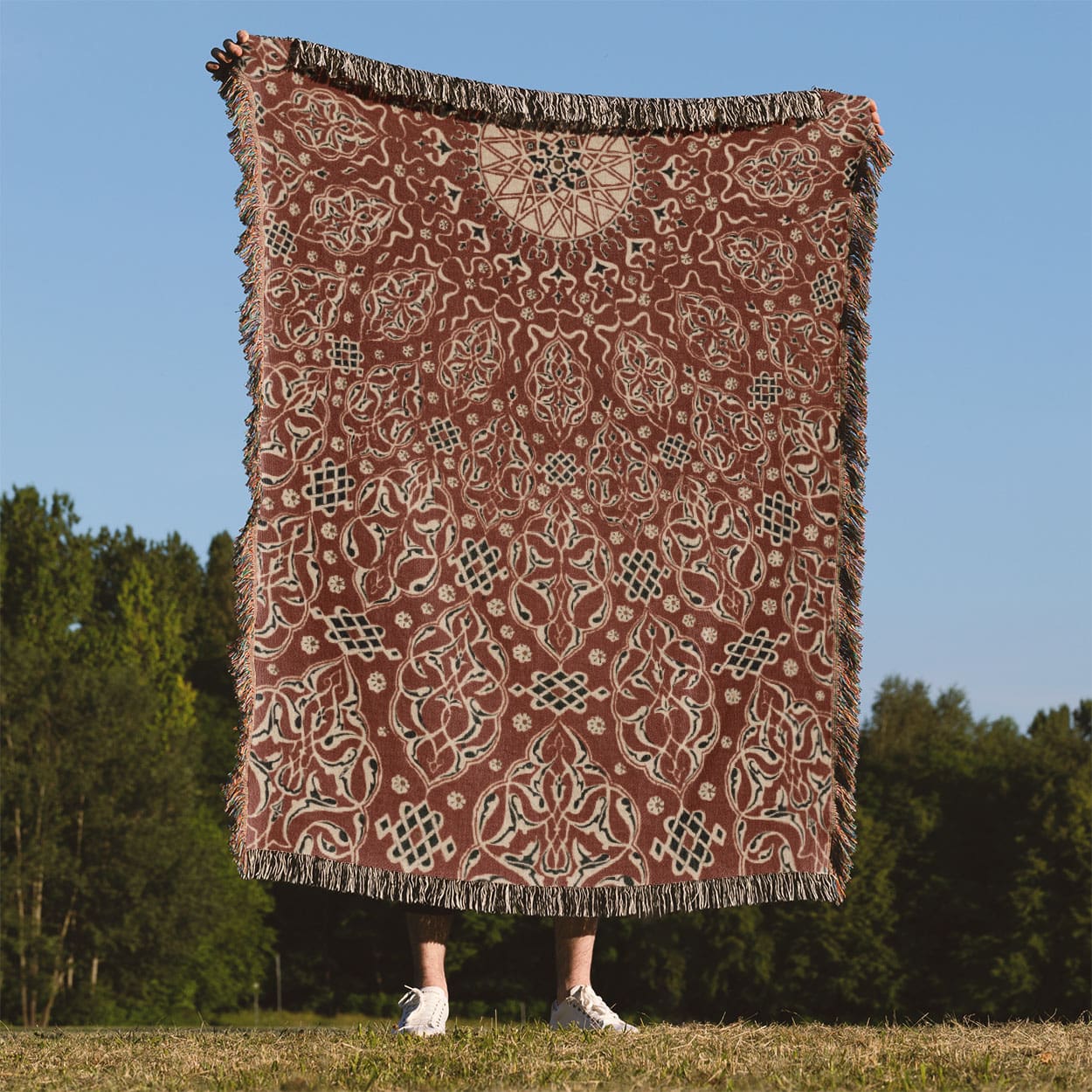 Bright Red Pattern Woven Blanket Held Up Outside