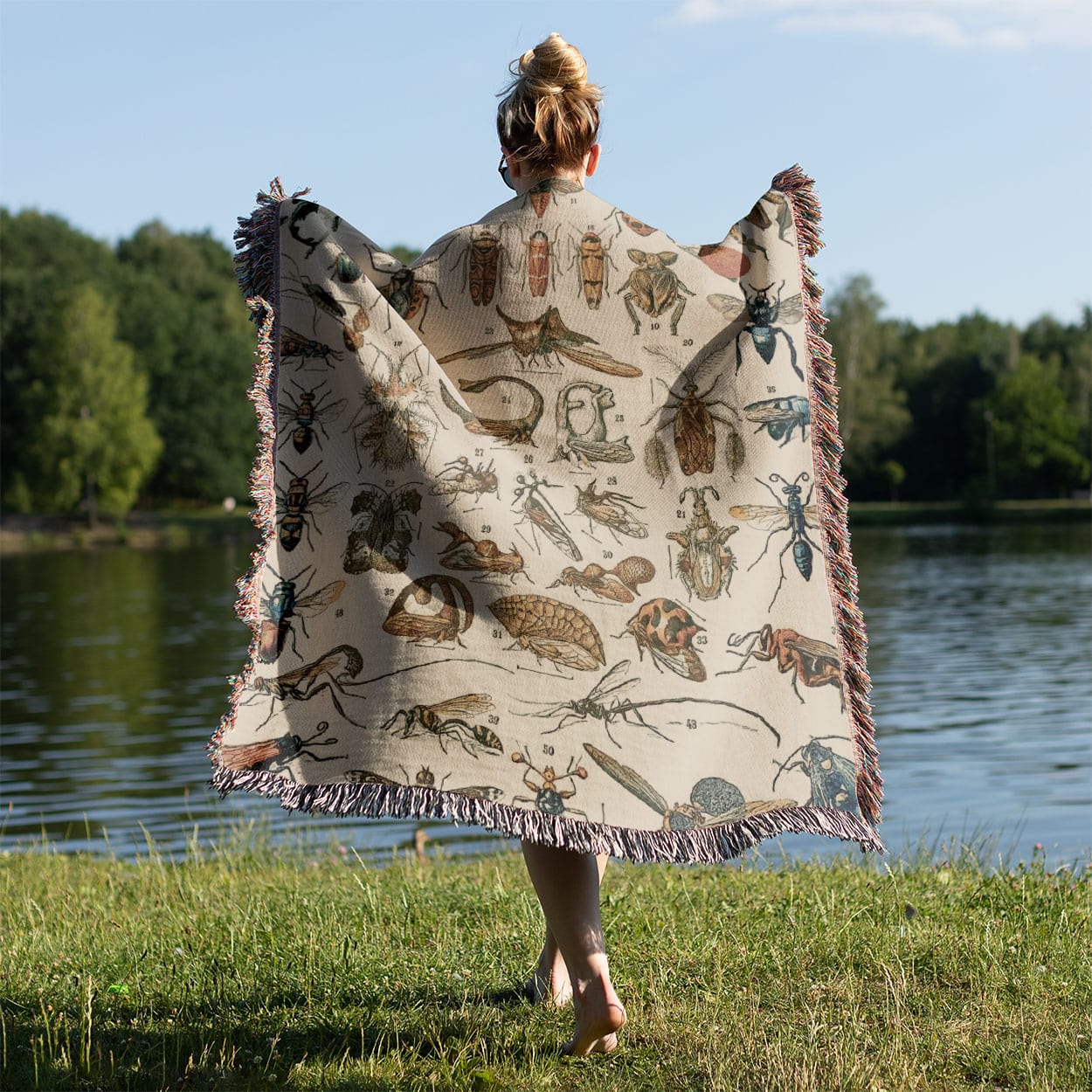 Bugs and Insects Woven Blanket Held on a Woman's Back Outside
