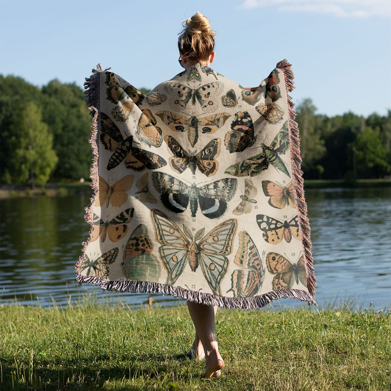 Butterflies Woven Blanket Held on a Woman's Back Outside