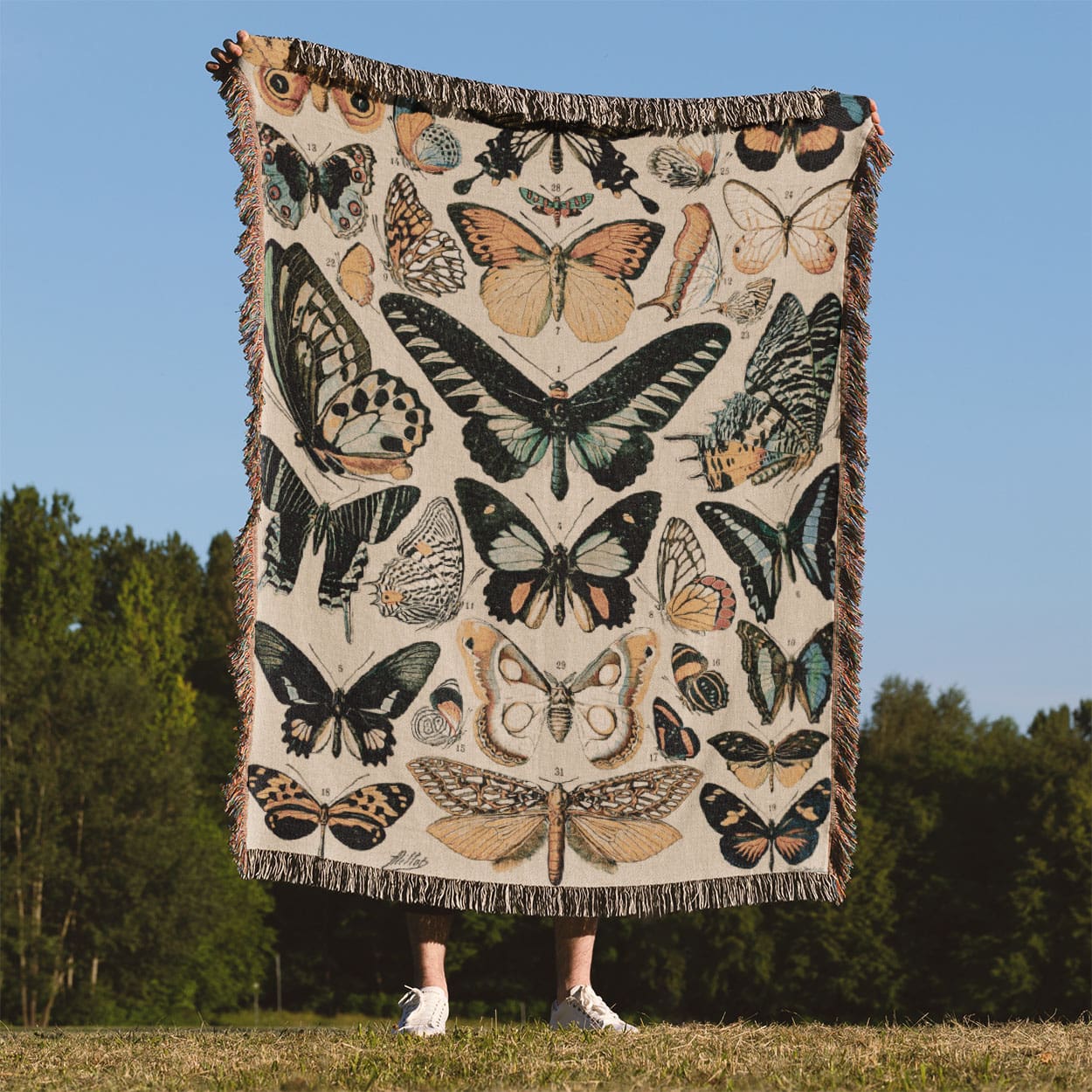Butterflies and Moths Woven Blanket Held Up Outside