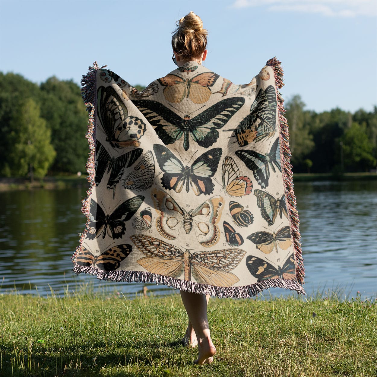 Butterflies and Moths Woven Blanket Held on a Woman's Back Outside
