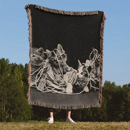 Cats Tangled in Yarn Woven Blanket Held Up Outside
