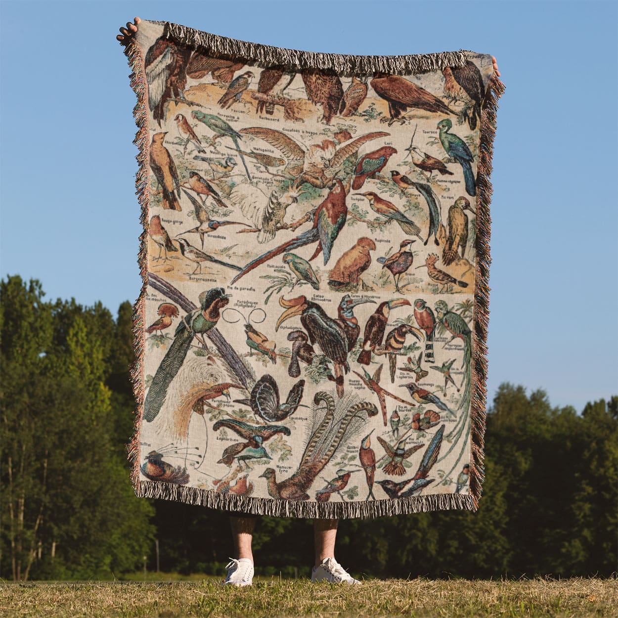 Collection of Birds Woven Throw Blanket Held Up Outside