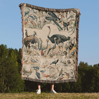 Collection of Birds Woven Throw Blanket Held Up Outside