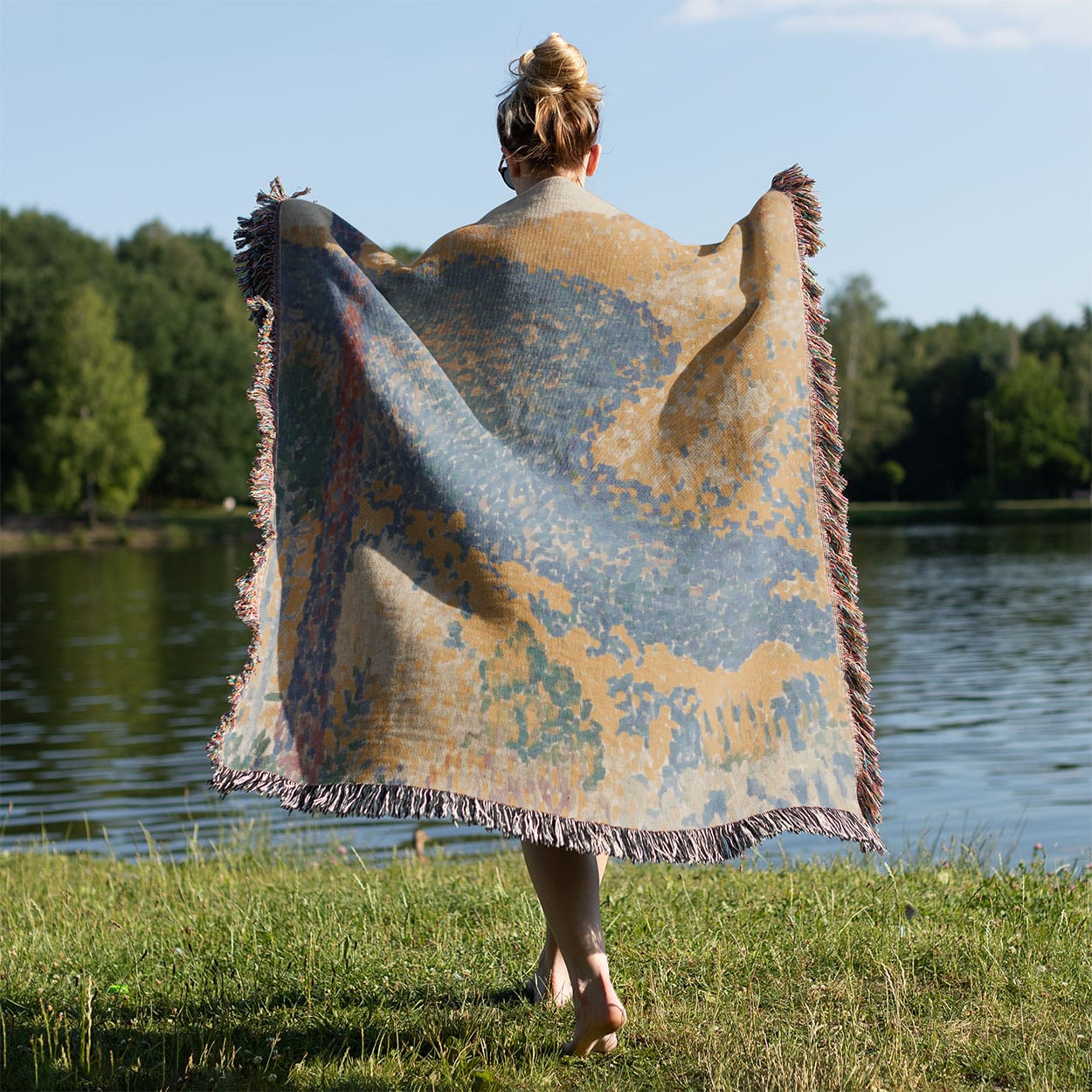 Colorful Landscape Woven Throw Blanket Held on a Woman's Back Outside