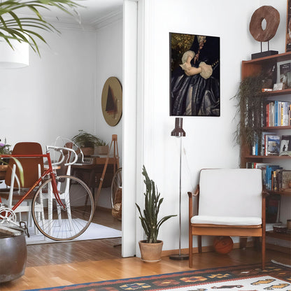 Eclectic living room with a road bike, bookshelf and house plants that features framed artwork of a Letter in Hands above a chair and lamp