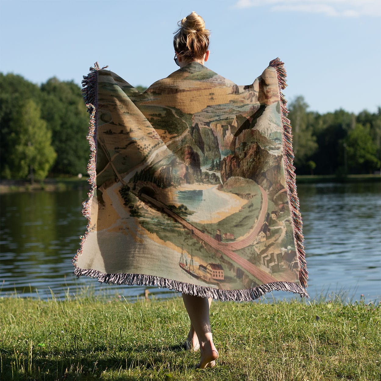 Cool Landscape Woven Blanket Held on a Woman's Back Outside