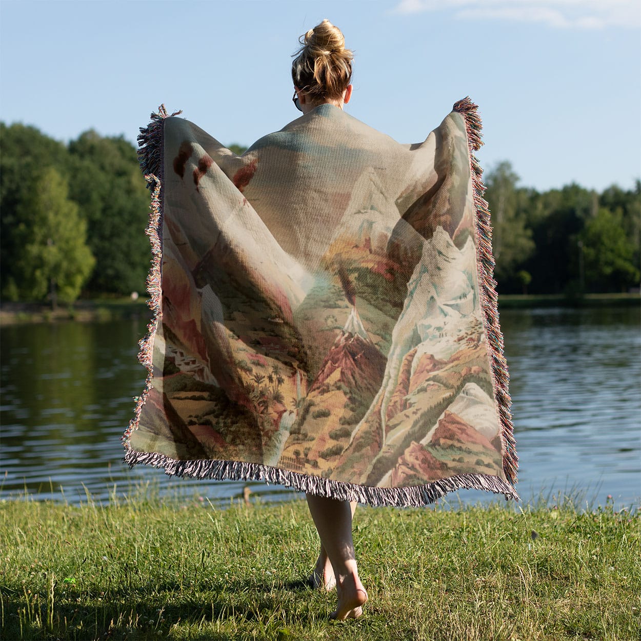 Cool Mountain Painting Woven Throw Blanket Held on a Woman's Back Outside