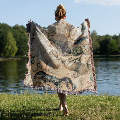 Corals and Jellyfish Woven Blanket Held on a Woman's Back Outside