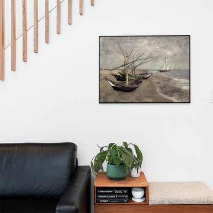 Living space with a black leather couch and table with a plant and books below a staircase featuring a framed picture of Nautical