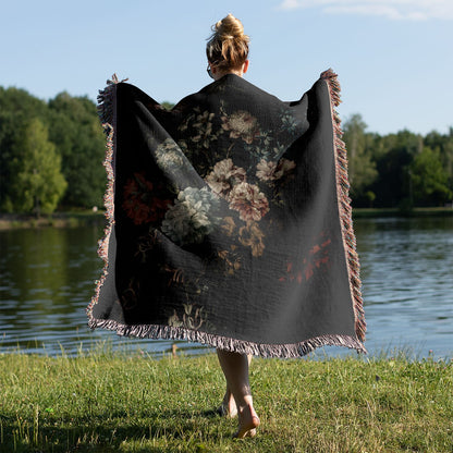 Dark Floral Woven Blanket Held on a Woman's Back Outside