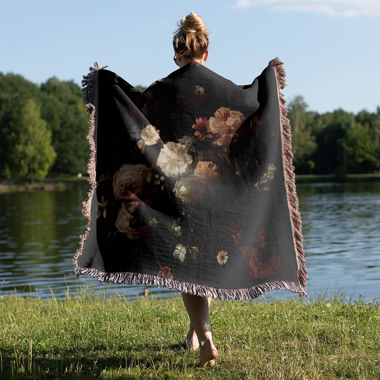 Dark Flowers Woven Blanket Held on a Woman's Back Outside
