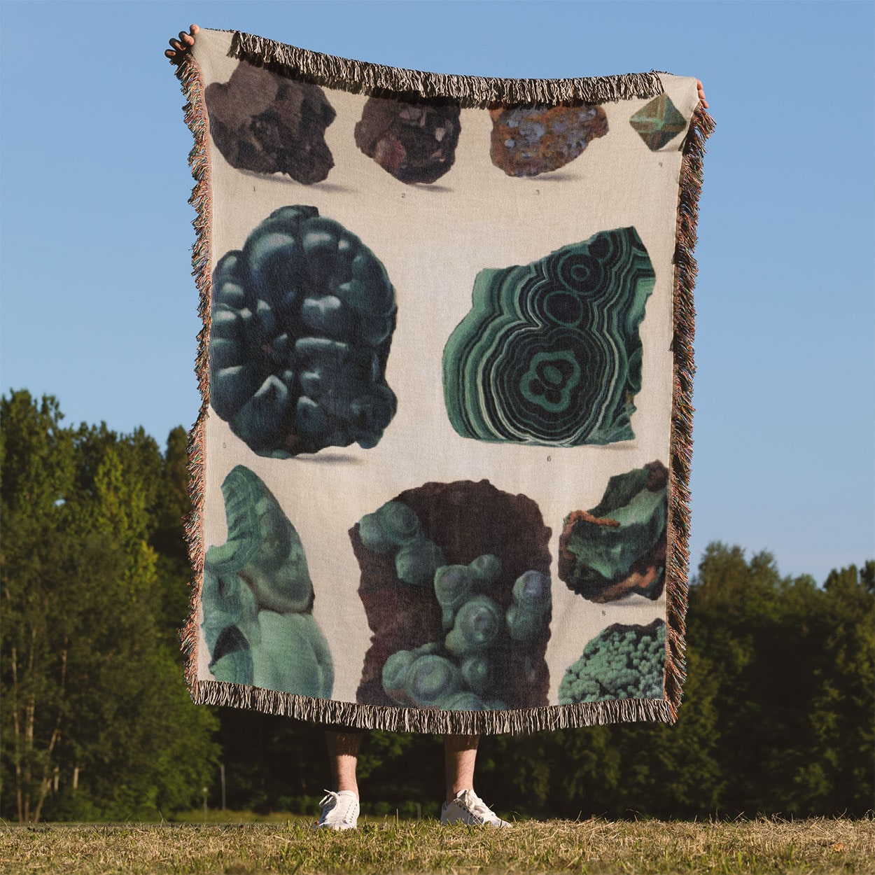 Dark Rocks and Jade Woven Blanket Held Up Outside