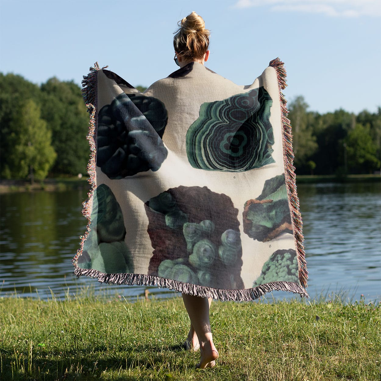 Dark Rocks and Jade Woven Blanket Held on a Woman's Back Outside