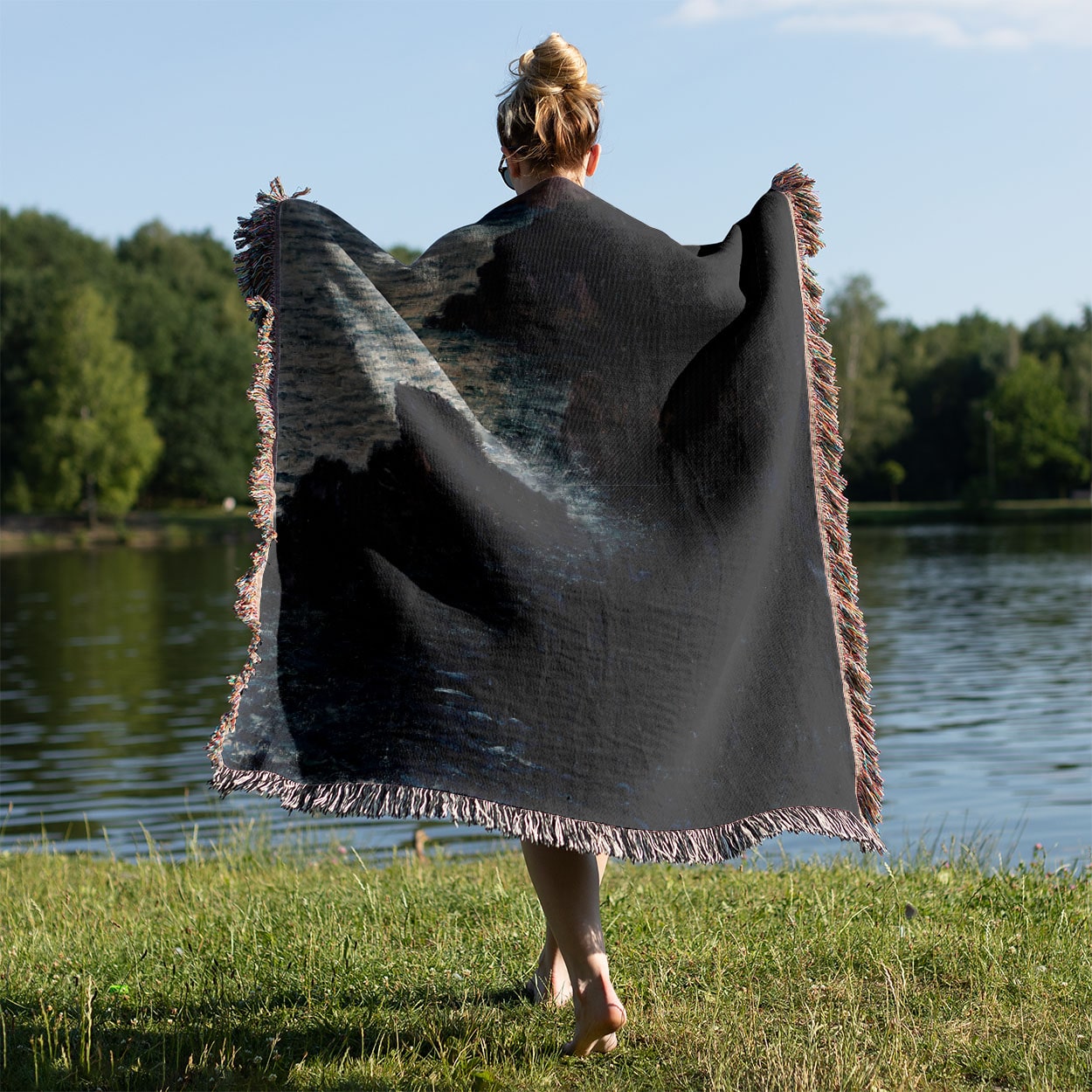 Dark Sea Woven Blanket Held on a Woman's Back Outside