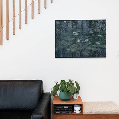 Living space with a black leather couch and table with a plant and books below a staircase featuring a framed picture of Relaxing Abstract