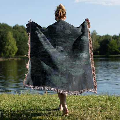 Deep Blue and Green Woven Blanket Held on a Woman's Back Outside