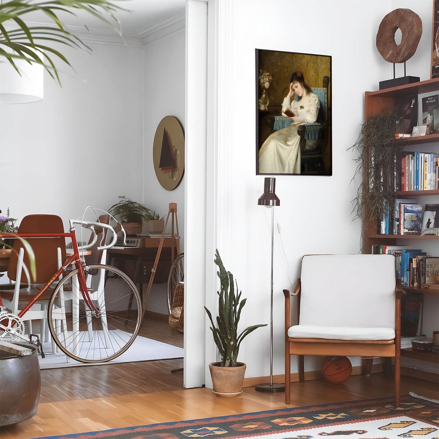 Eclectic living room with a road bike, bookshelf and house plants that features framed artwork of a Concentrated Reading above a chair and lamp