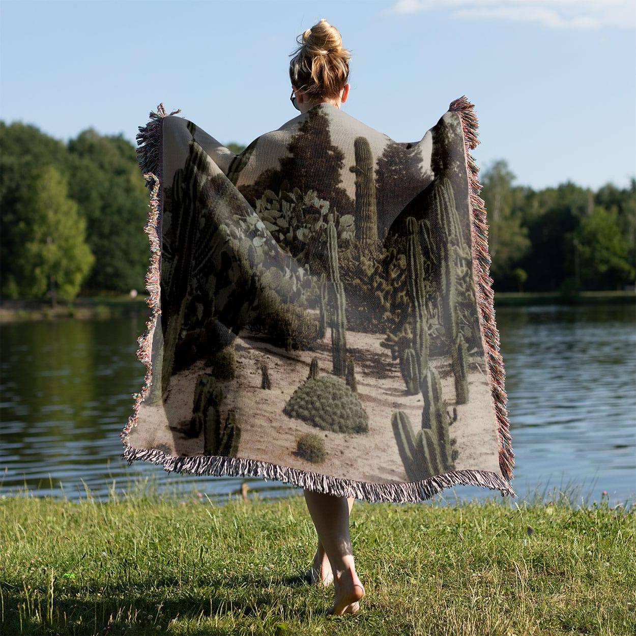 Desert Landscape Woven Blanket Held on a Woman's Back Outside