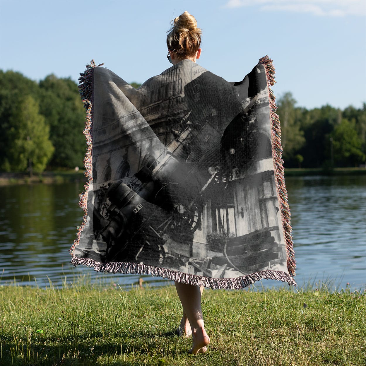 Disaster Woven Blanket Held on a Woman's Back Outside