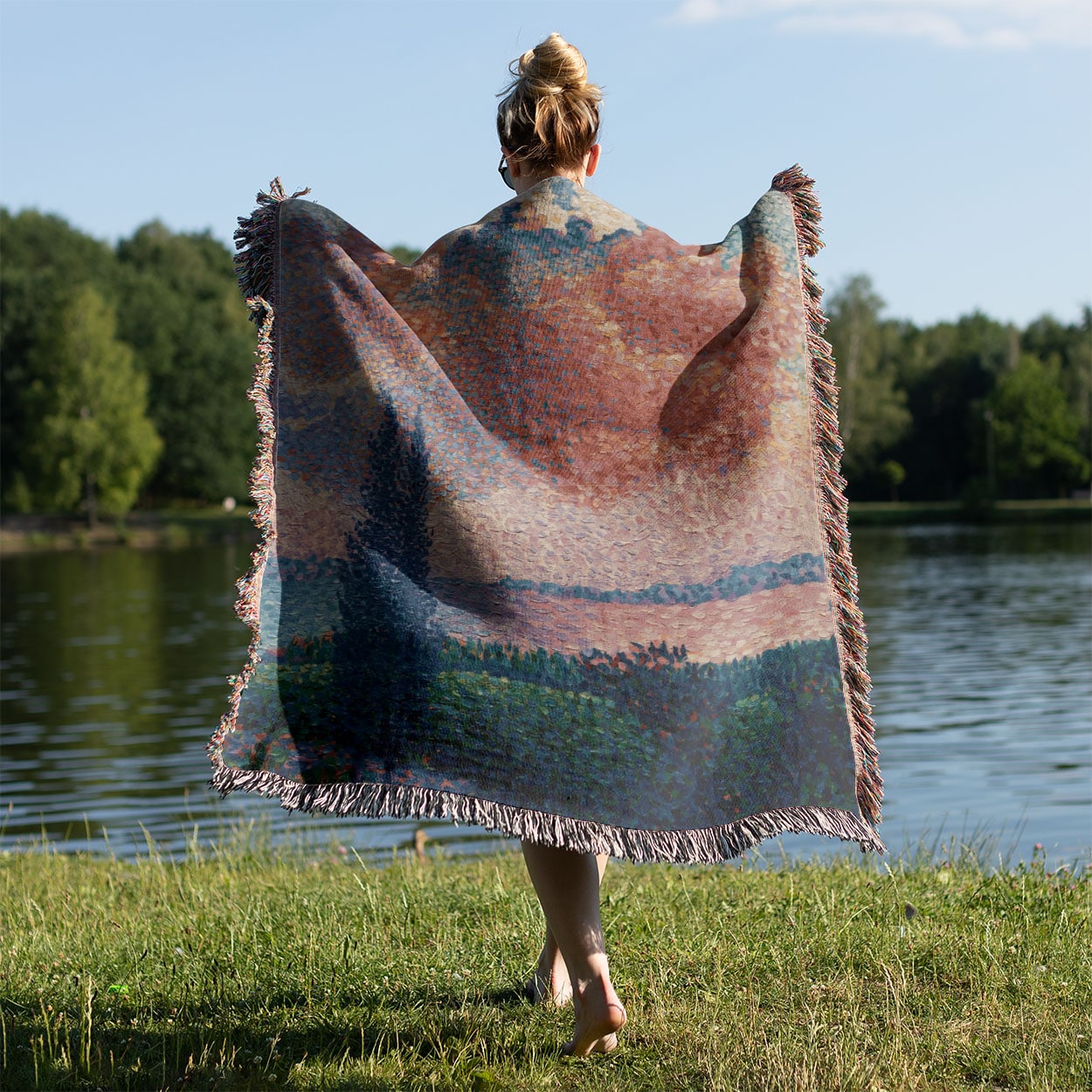 Dreamy Landscape Woven Blanket Held on a Woman's Back Outside