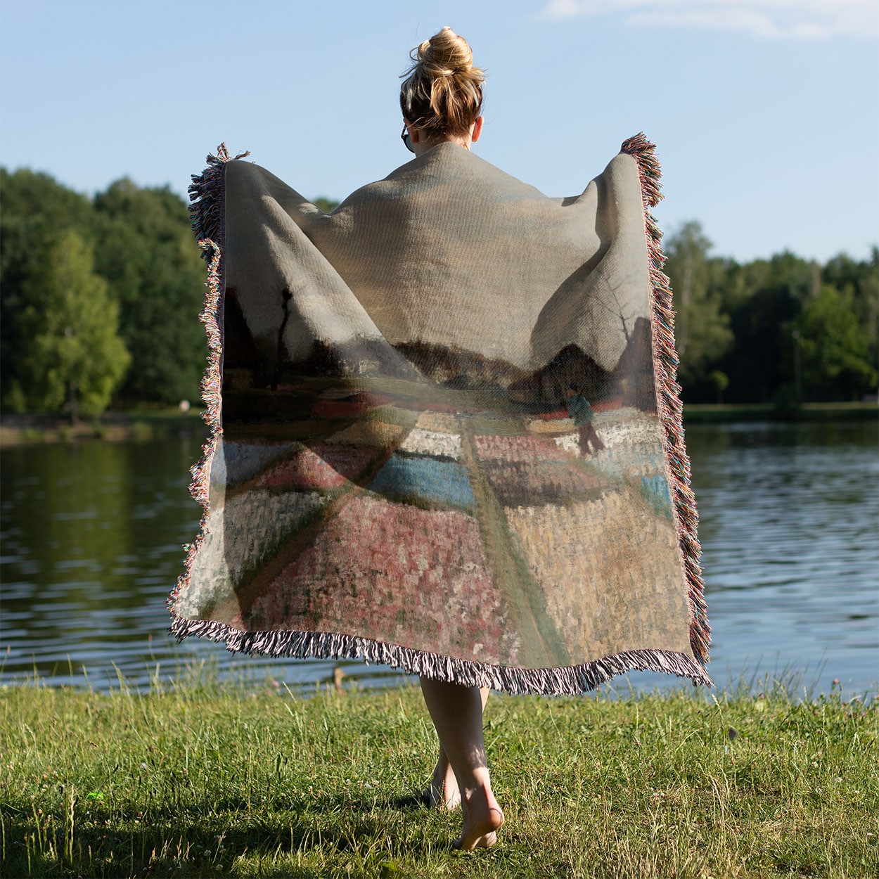 Floral Landscape Woven Blanket Held on a Woman's Back Outside
