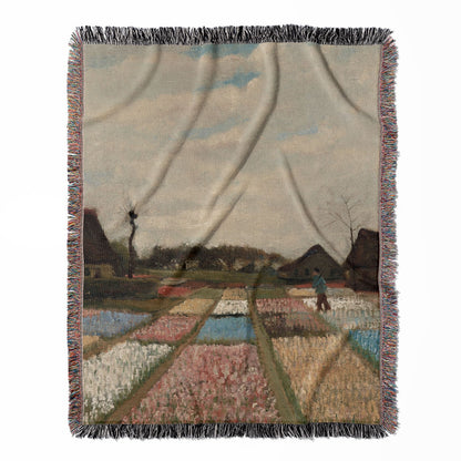 Floral Landscape woven throw blanket, made with 100% cotton, providing a soft and cozy texture with a flower field painting for home decor.