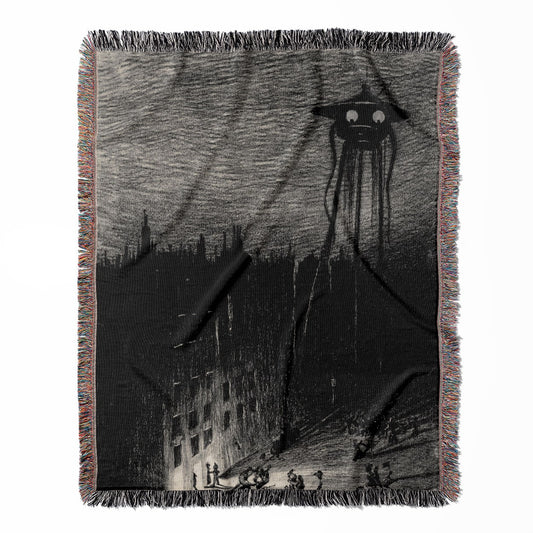 War of the Worlds woven throw blanket, made with 100% cotton, providing a soft and cozy texture with a funny alien drawing for home decor.