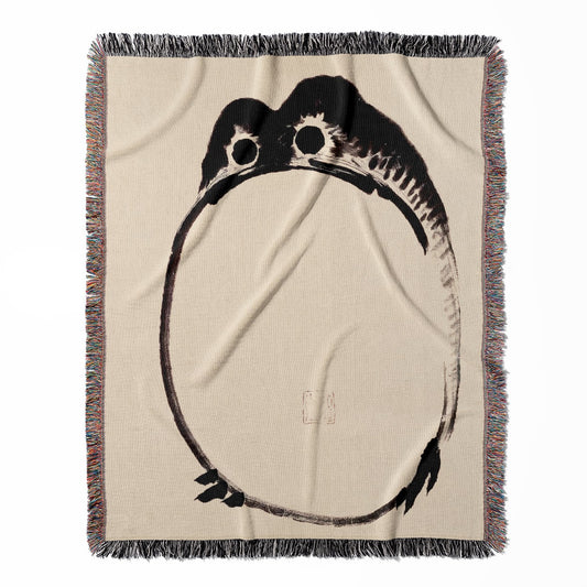 Funny Japanese Toad woven throw blanket, made of 100% cotton, presenting a soft and cozy texture with a depressed frog design for home decor.