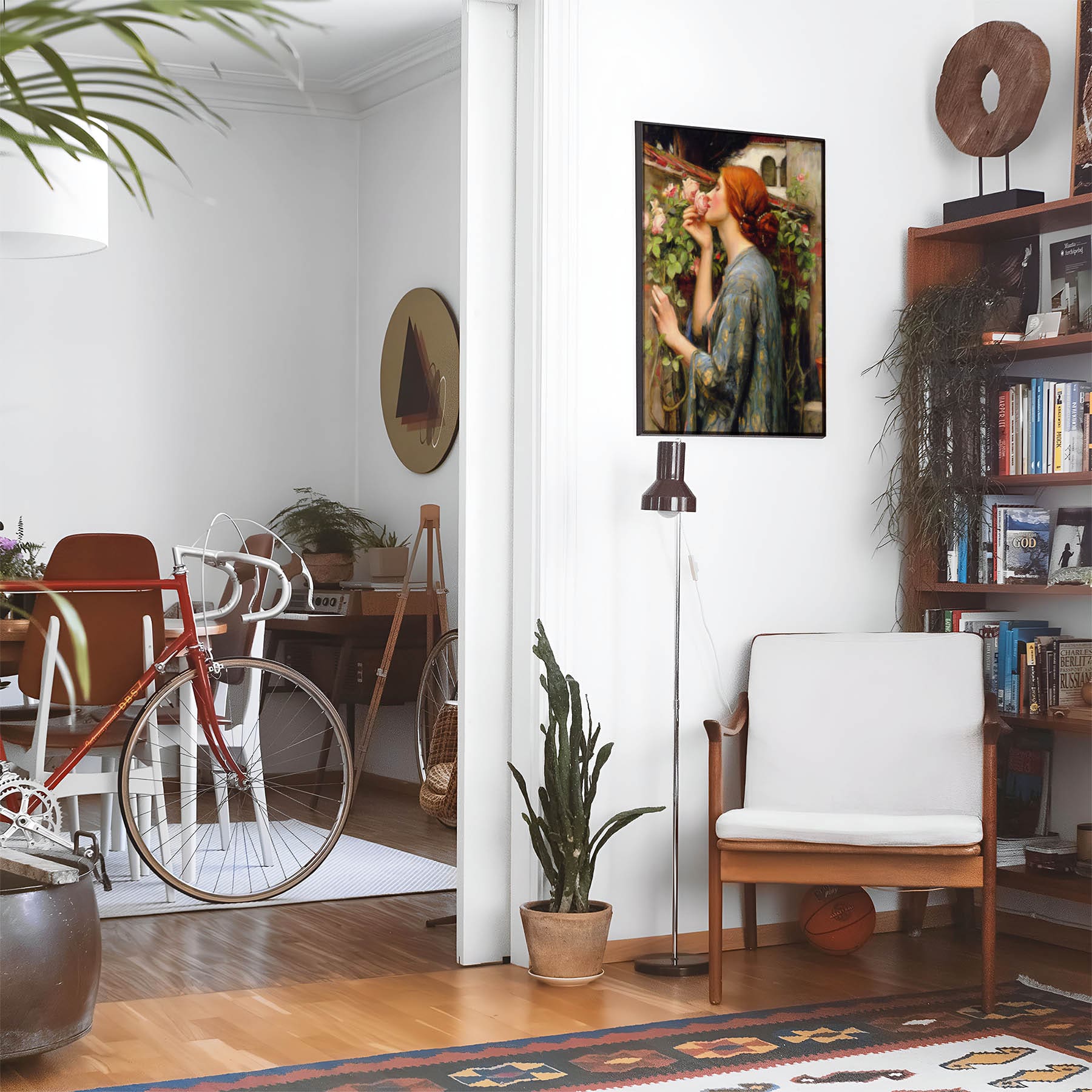 Eclectic living room with a road bike, bookshelf and house plants that features framed artwork of a Woman with Red Hair Smelling a Rose above a chair and lamp