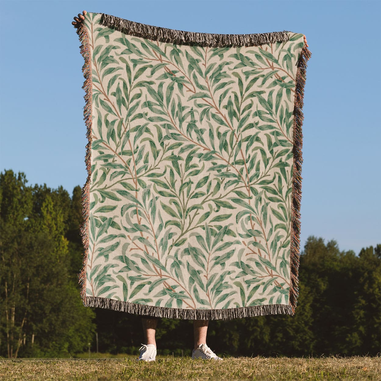 Green Leaf Woven Blanket Held Up Outside