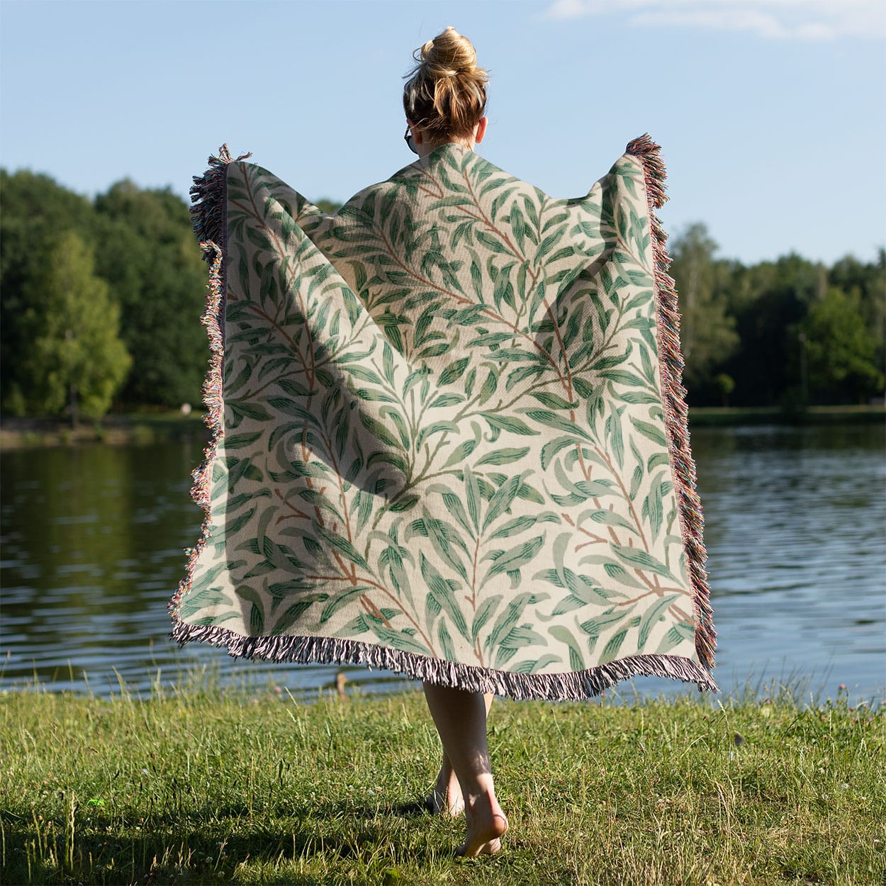 Green Leaf Woven Blanket Held on a Woman's Back Outside