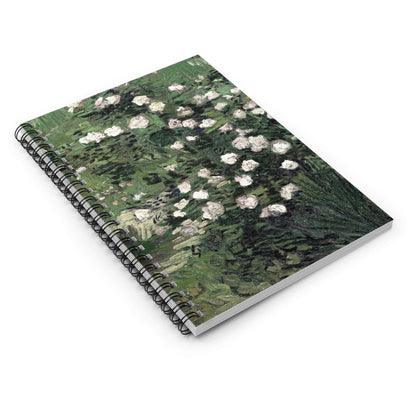 Green with White Flowers Spiral Notebook Laying Flat on White Surface